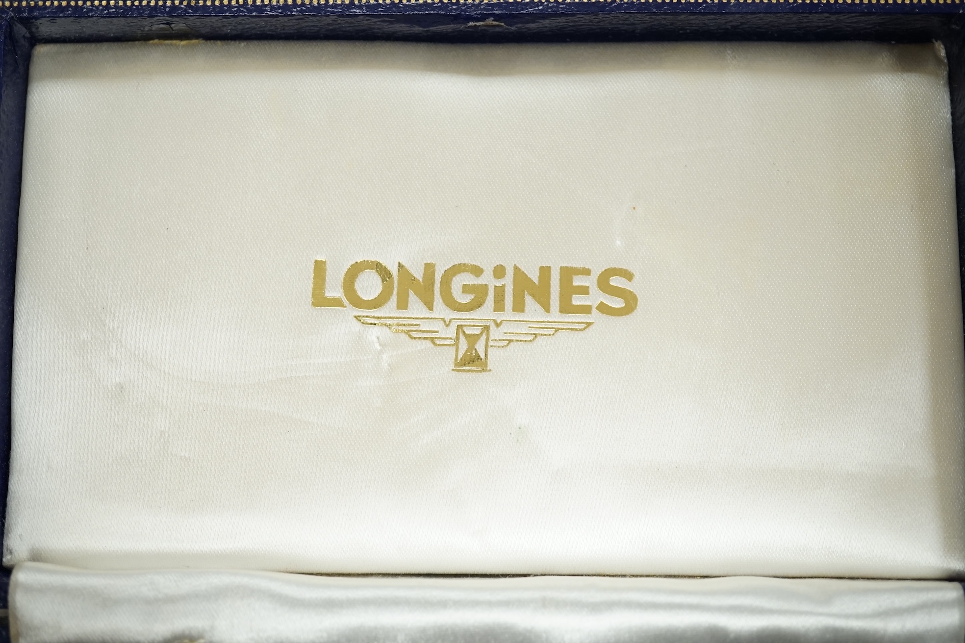 A gentleman's 9ct gold Longines manual wind wrist watch, with subsidiary seconds, case diameter 34mm, on a later associated leather strap, with Longines box. Condition - fair